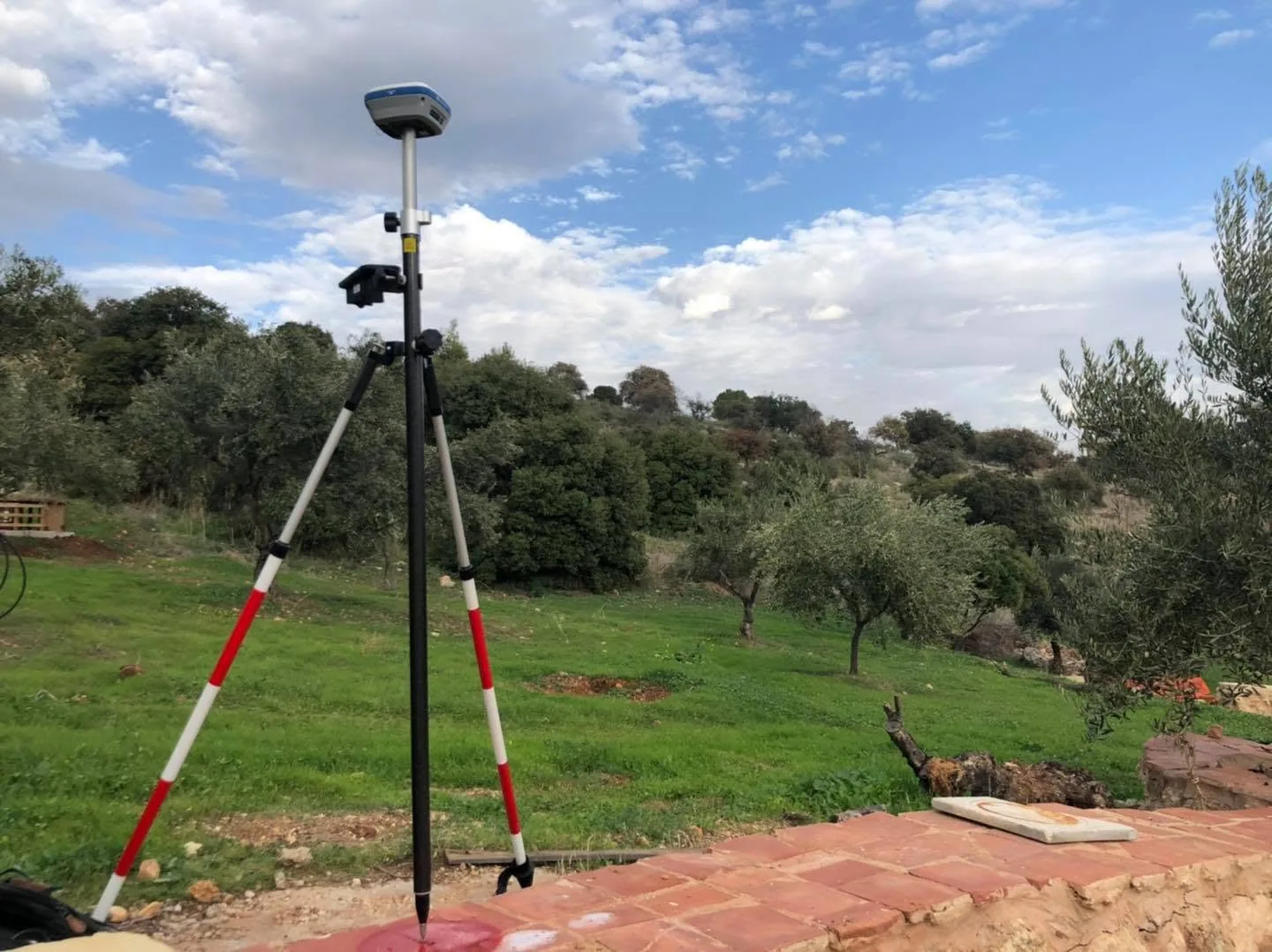 Surveyor carrying out GNSS measurements in mountainous terrain