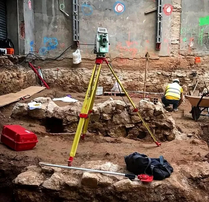 Total station documenting an excavation site